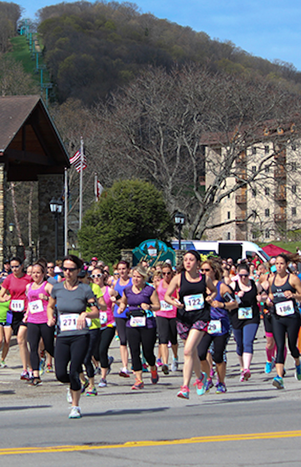 A large group of runners participating in the Happy Half Marathon.